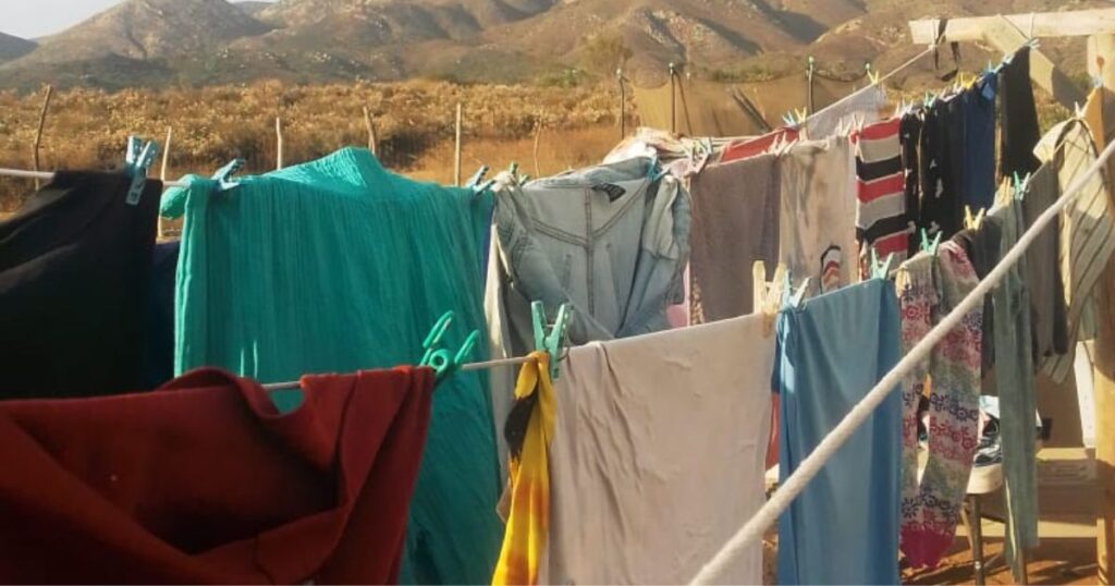 laundry hanging outside on clothesline with mountains in background.