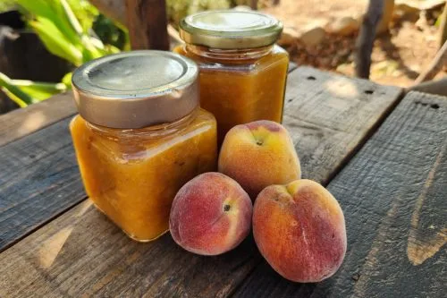 peach jam and peaches on wood chair.