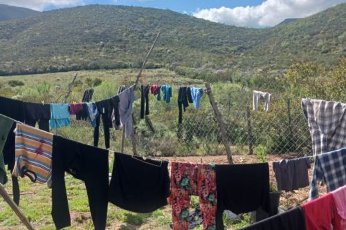 clothes hanging to dry with mountains in background.