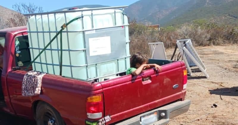 water filled water tank in back of red truck