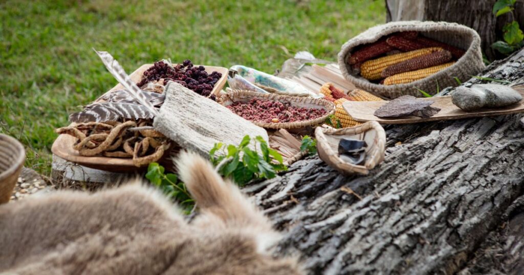 Wood table outside with grains displayed.