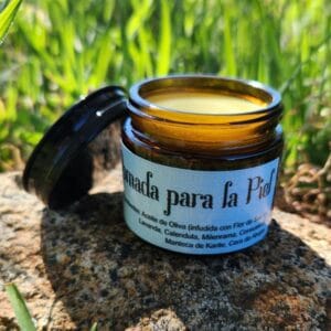 jar of tierra libre salve pomada on a rock outside